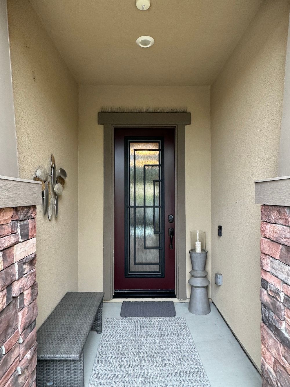 A hallway with a bench and a door in a house.