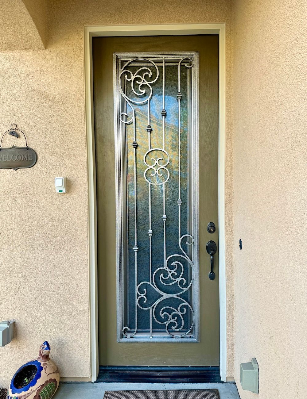 A front door with a wrought iron design on it
