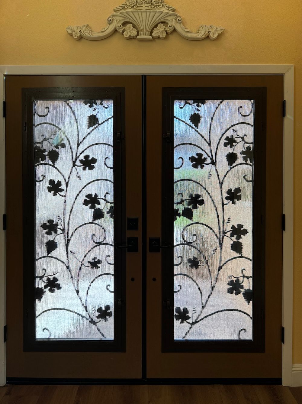 A pair of doors with a wrought iron design on them