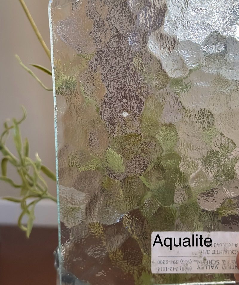 A glass with a label that says aqualite on it