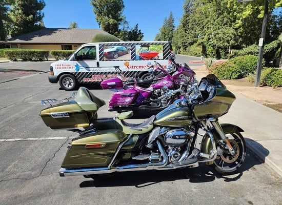 a row of harley davidson motorcycles parked next to a van