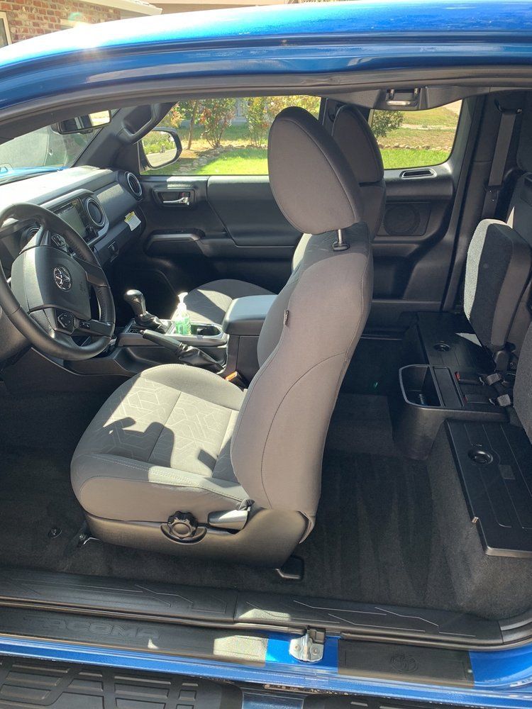 the interior of a blue toyota tacoma truck with the door open