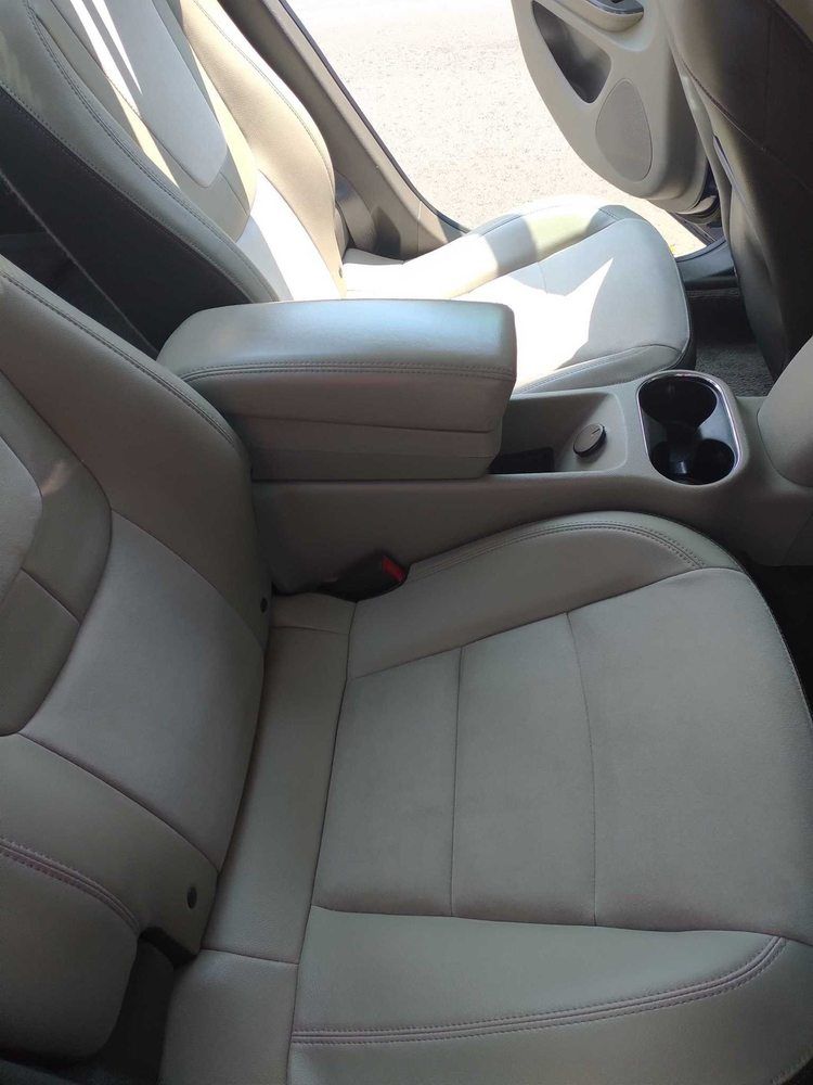 a car with white leather seats and a center console