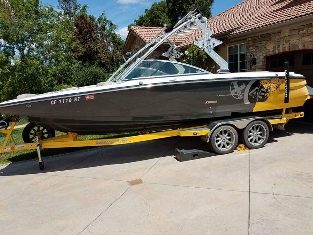 a boat is parked in a driveway next to a house