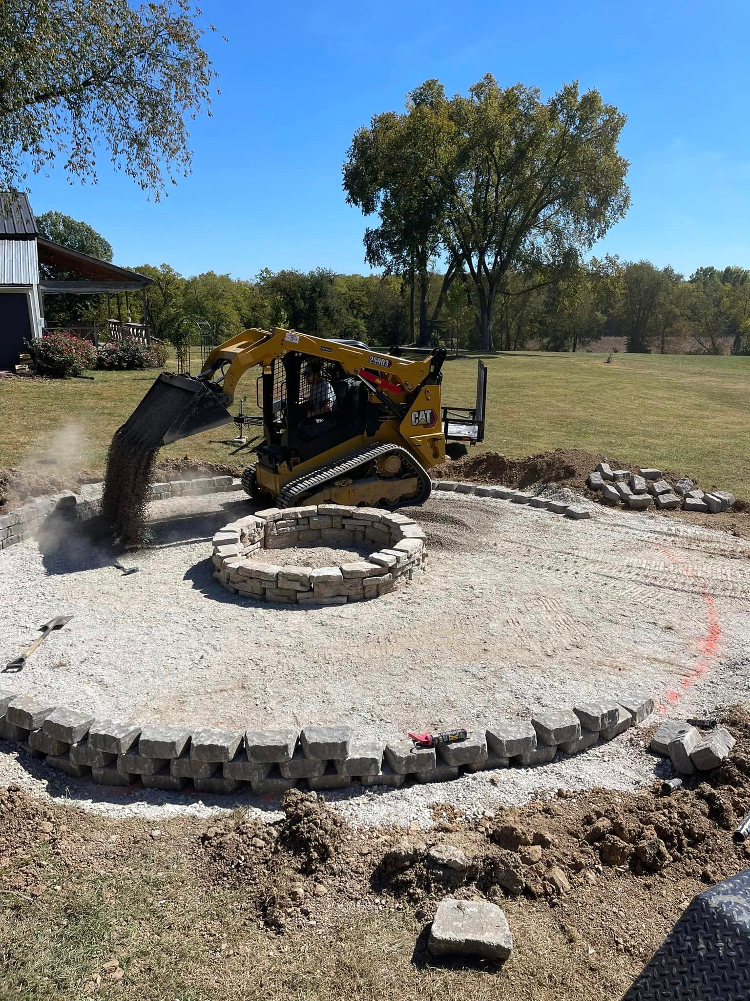 A Bulldozer is Digging a Hole in the Ground around a Fire Pit - Mount Washington, KY - God’s Country Outdoor Services
