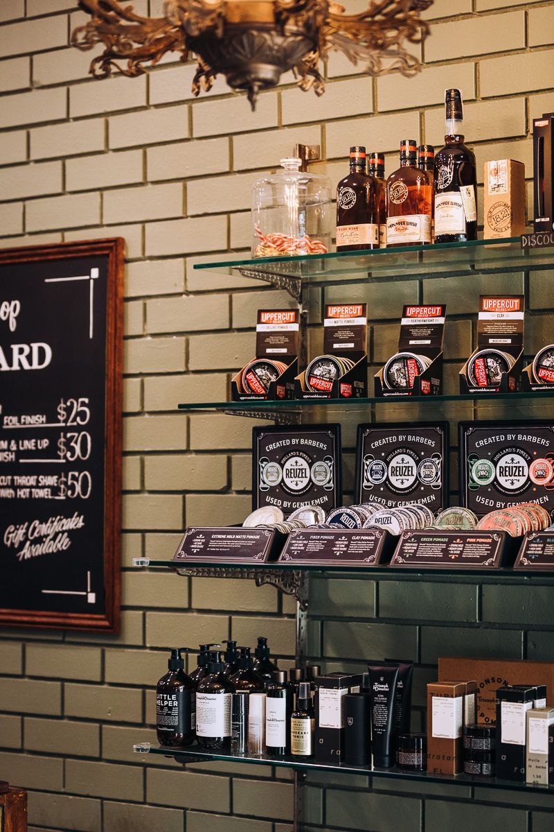 A barber shop with shelves filled with bottles and soaps.