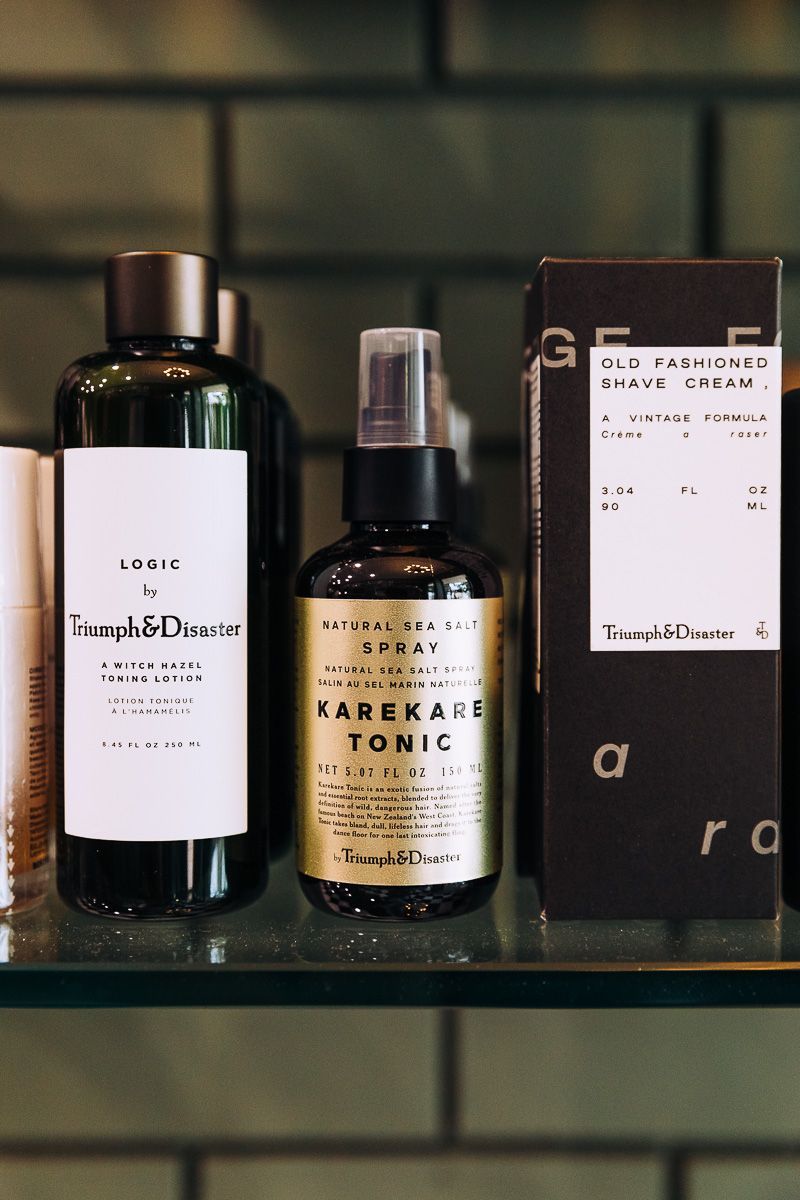 A bottle of care tonic sits on a glass shelf