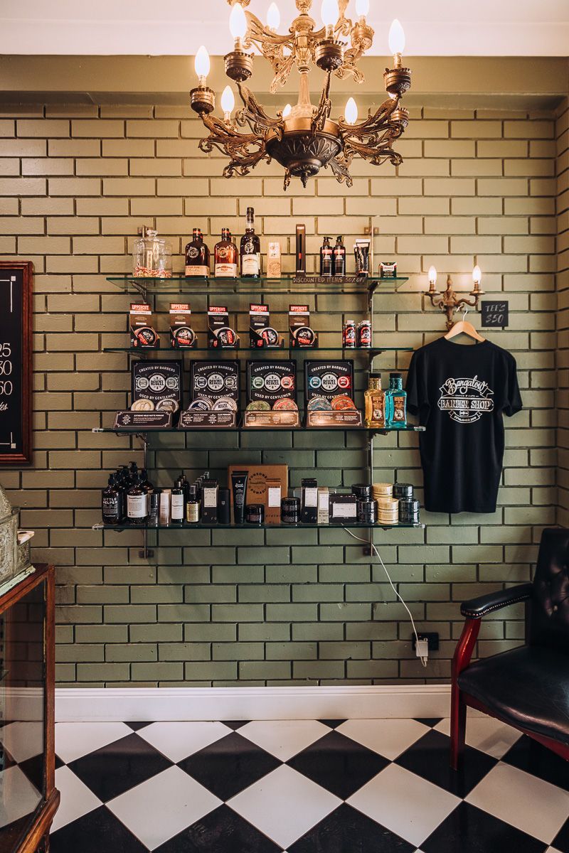 A barber shop with a checkered floor and a brick wall.
