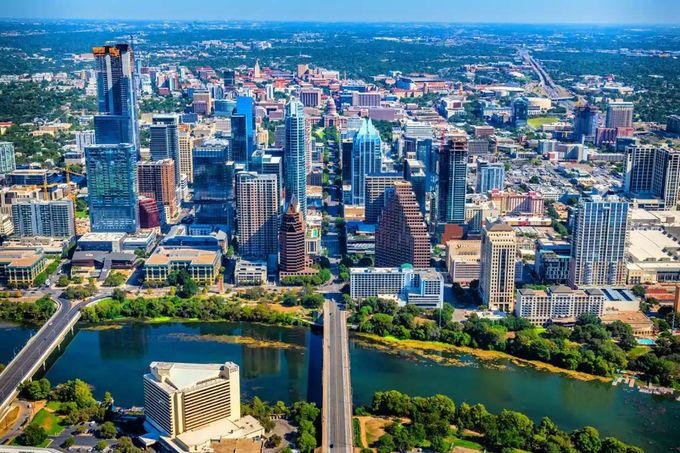 An aerial view of a city with a lake in the middle of it.