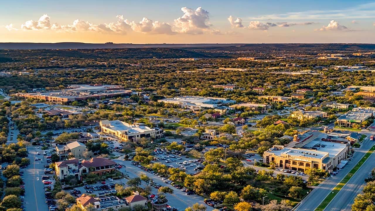 An aerial view of a city with lots of trees and buildings.