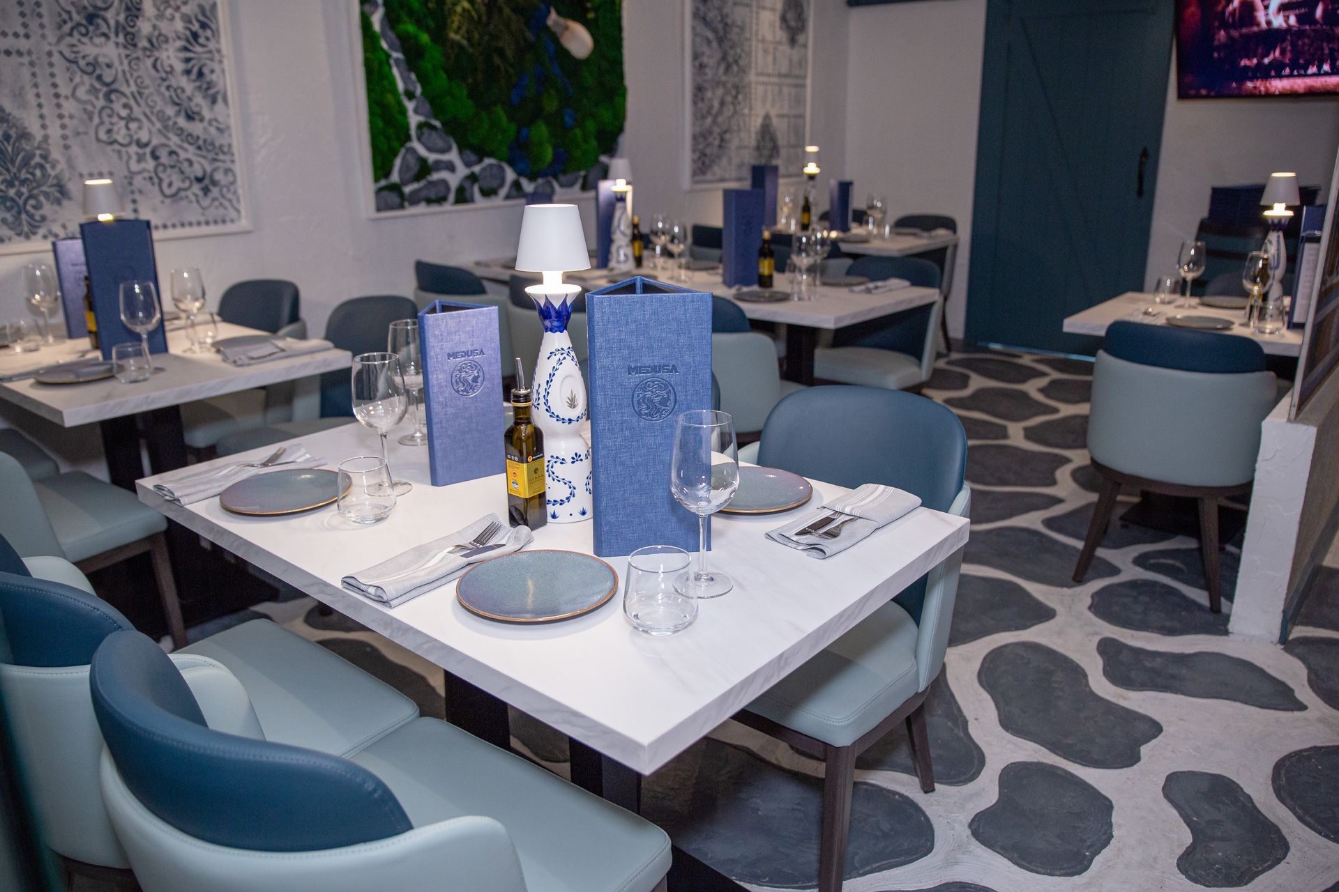 A restaurant with tables and chairs and a menu on the table.