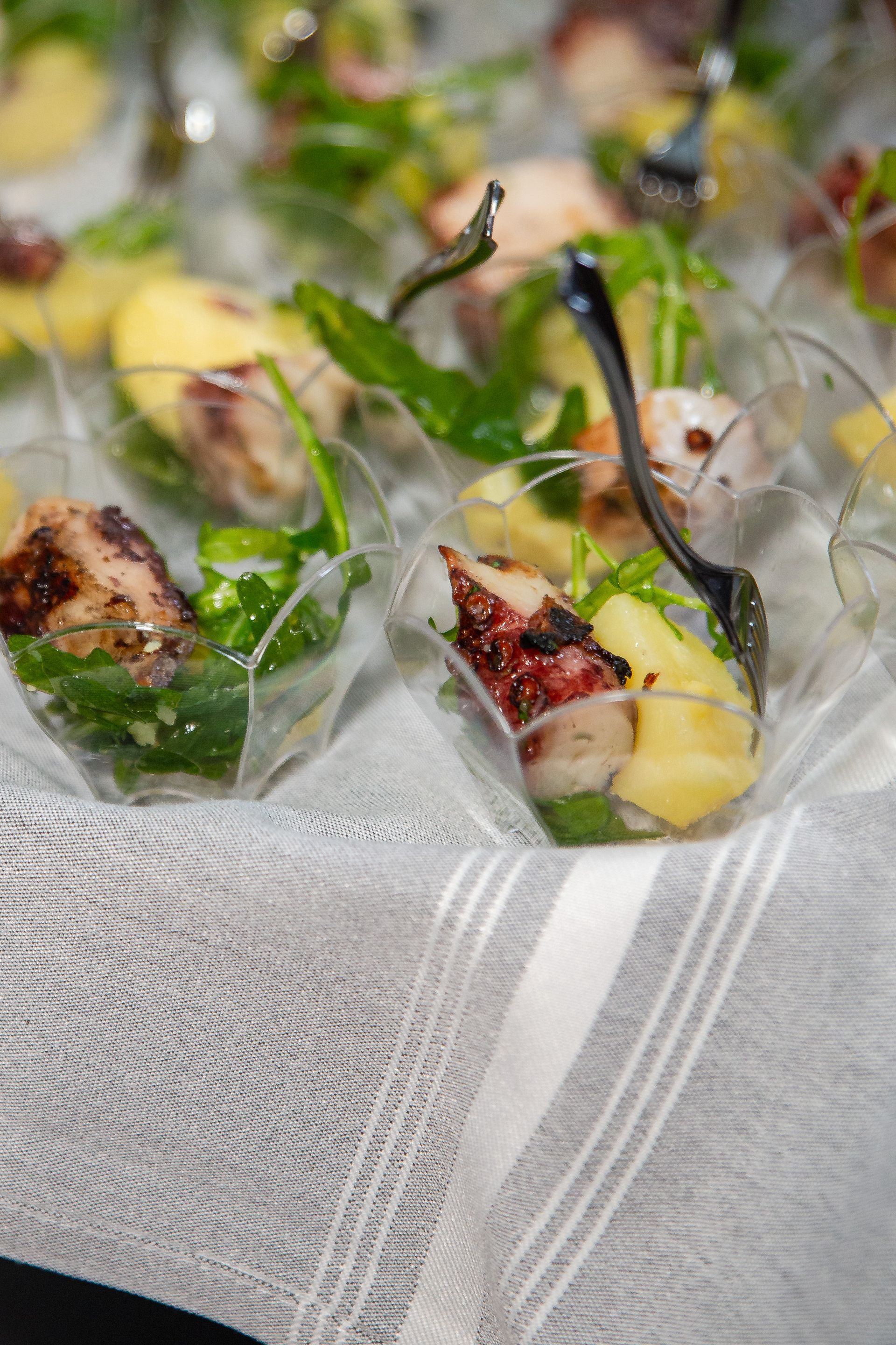 A close up of a plate of food with a spoon on a table.
