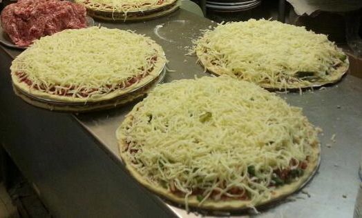 Three Pizzas Covered in Cheese