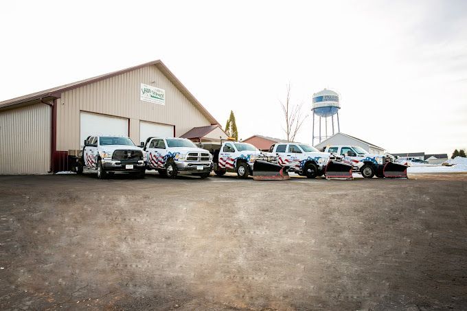 A row of trucks are parked in front of a building.