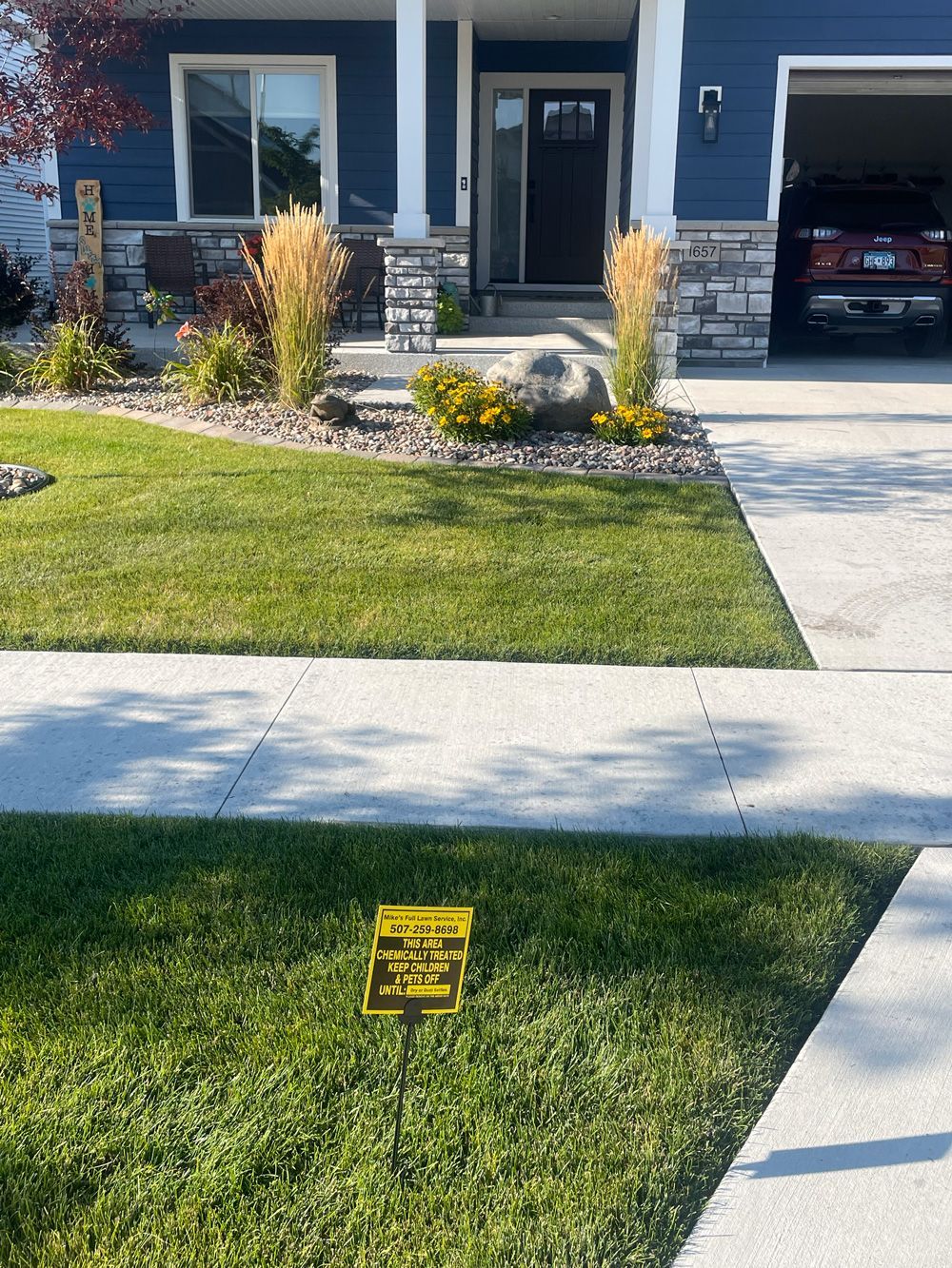 A truck is parked in a parking lot next to a drain.