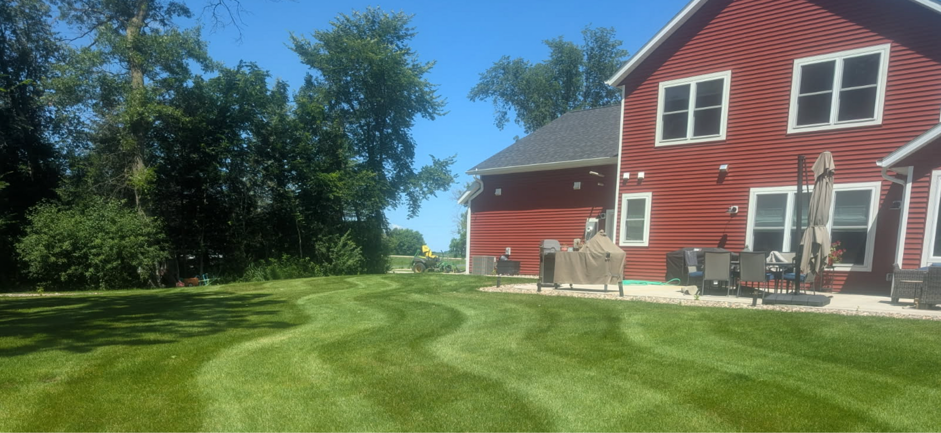A house with a porch and a garden in front of it.