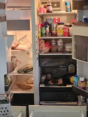 Open refrigerator filled with food items.