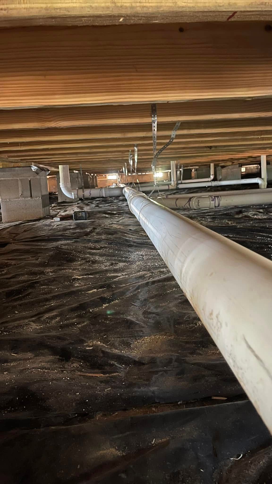 The bottom of a basement with a pipe going through it.