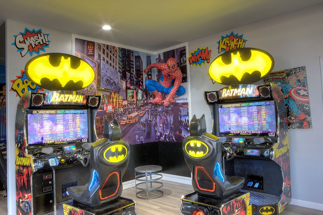 Mighty Smiles Dental, Dallas & Fort Worth. There are two batman and spiderman arcade games in the room.