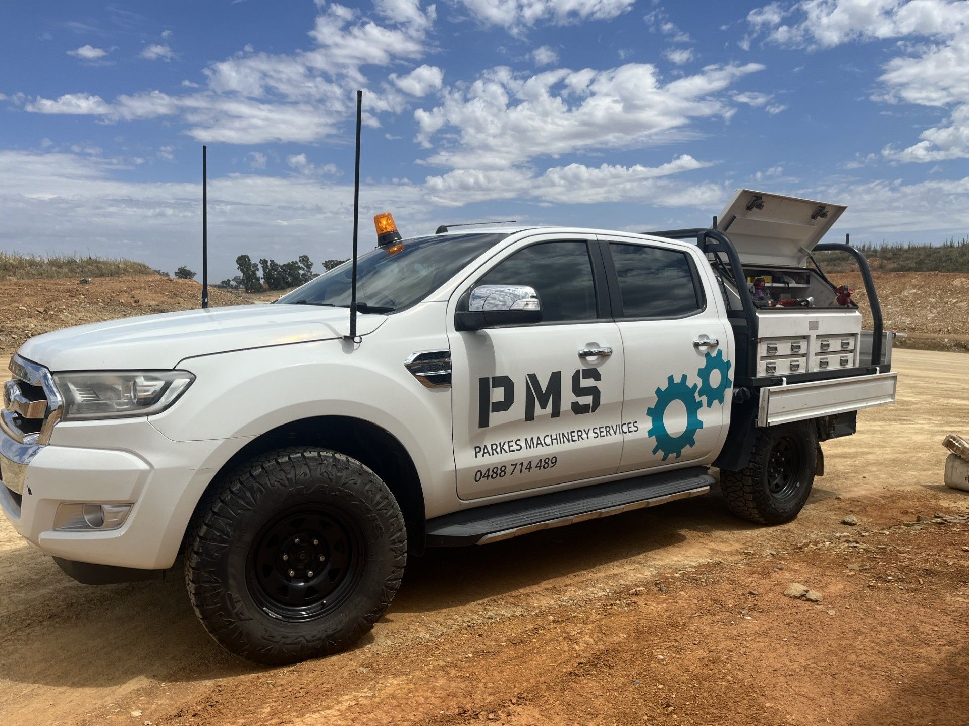 A Combine Harvester Is Cutting Wheat in A Field — Parkes Machinery Services PTY LTD in Parkes, NSW
