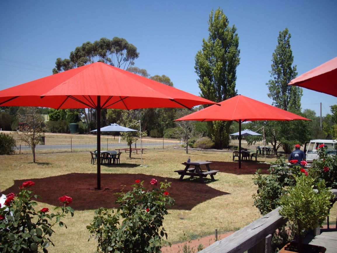 Red Umbrella & A Rose Plants — Custom Blinds in Corowa, NSW
