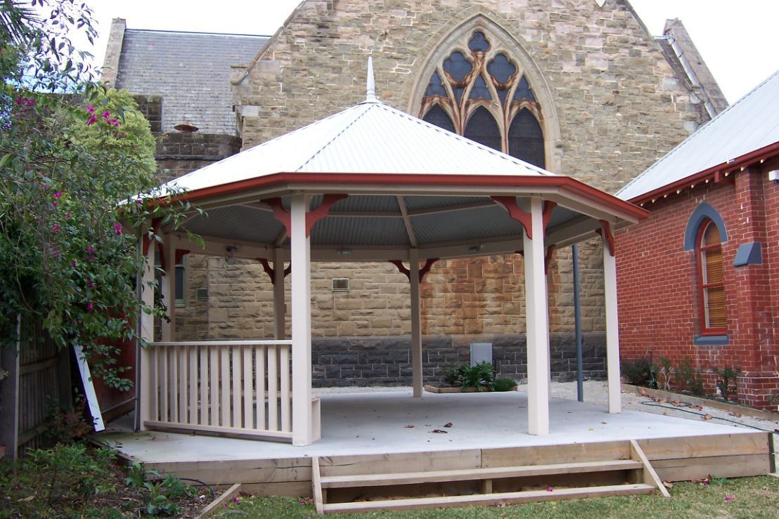 A Gazebo With A Brick Building In The Background - Gazebos in Albury, QLD