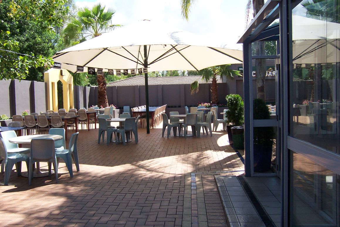 Tables & Chairs Under A Fixed Centre Pole Umbrella — Outdoor Umbrellas in Albury, NSW