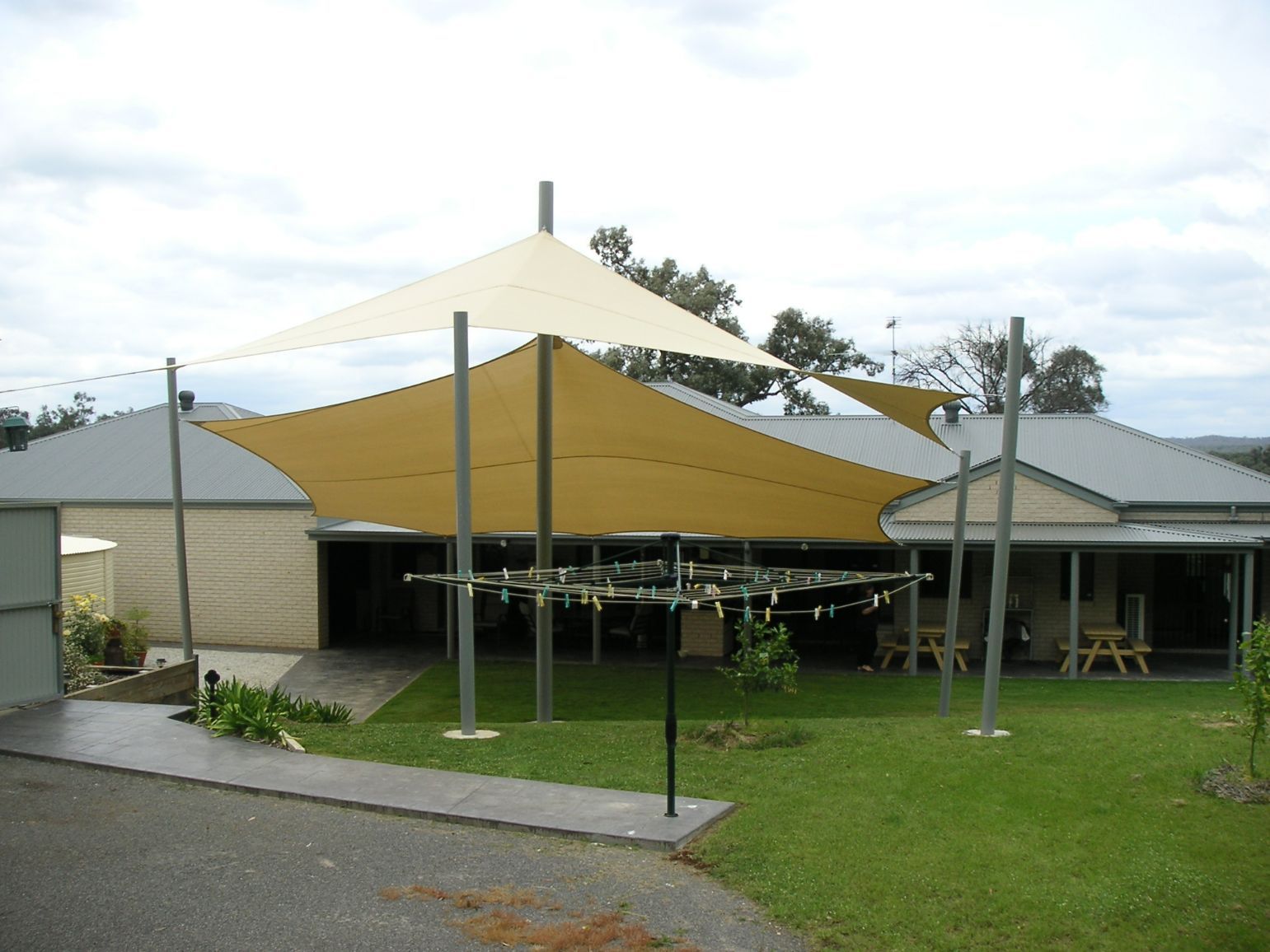 Clothes Rack Under The White Shade Sails — Custom Blinds in Yarrawonga, NSW