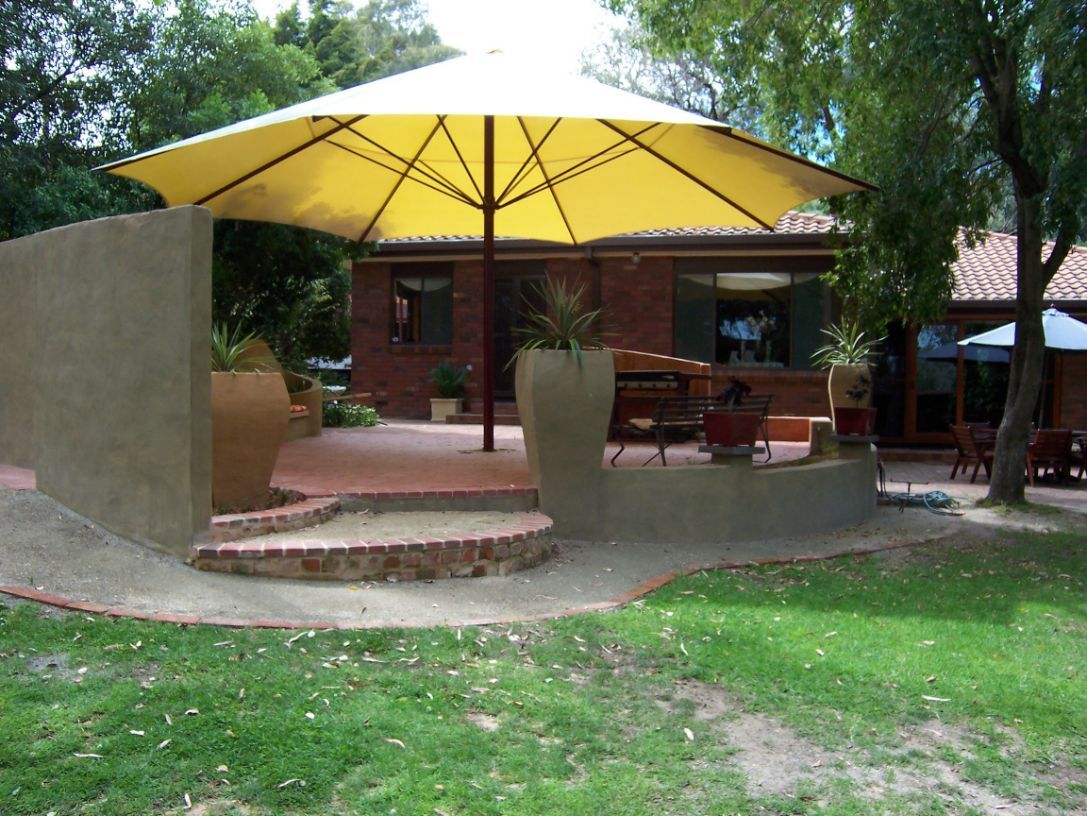 Centre Pole Umbrella At The Outdoor Area Of The House — Outdoor Umbrellas in Albury, NSW
