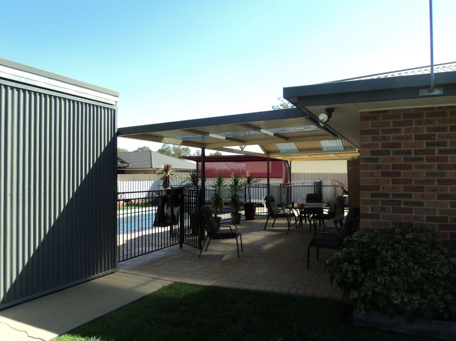Outdoor Area Of The House Near Red Cantilever Shade Structure — Custom Blinds in Albury, NSW