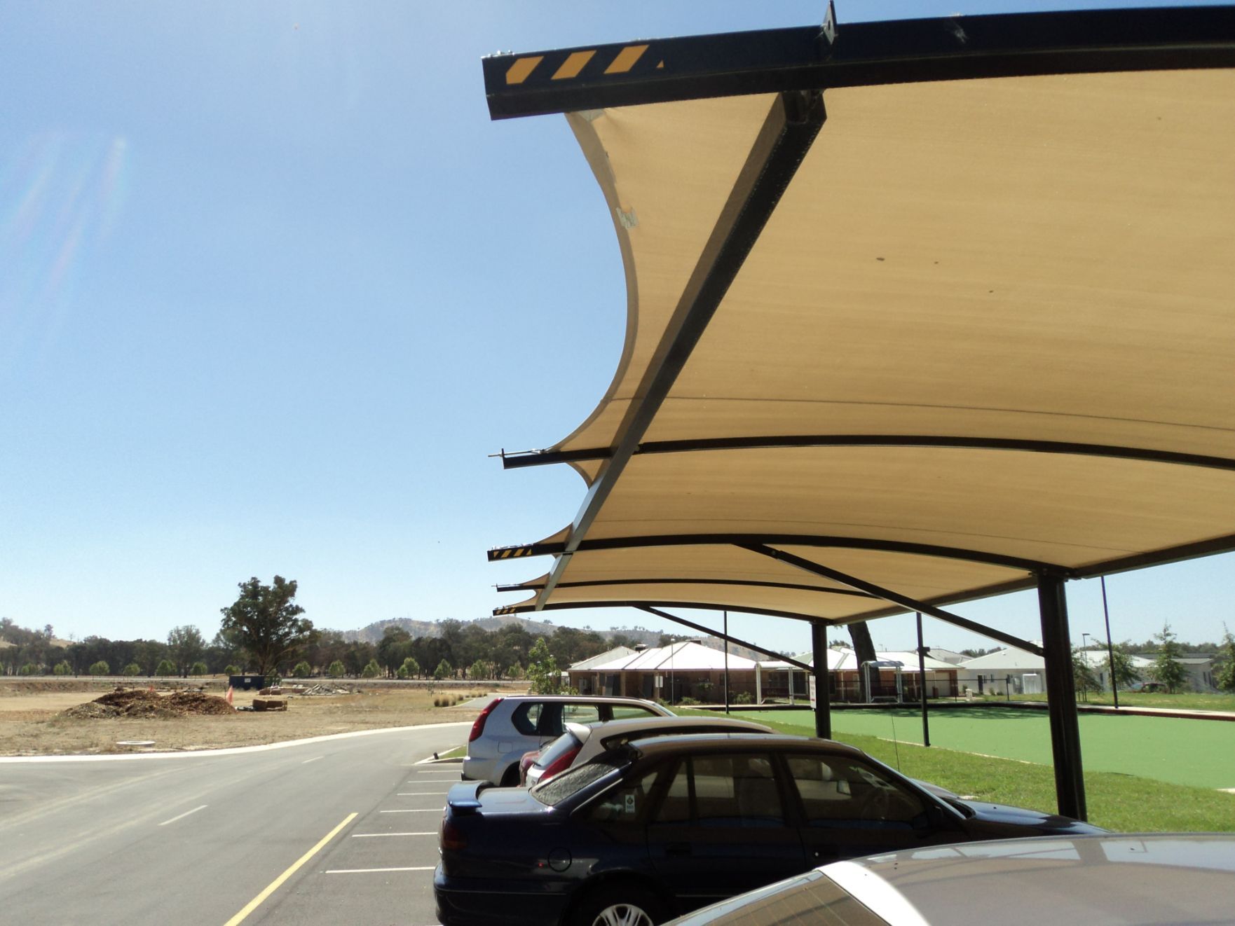 Beige Cantilever Shade Structure With Black Steel Frames — Custom Blinds in Wangaratta, NSW