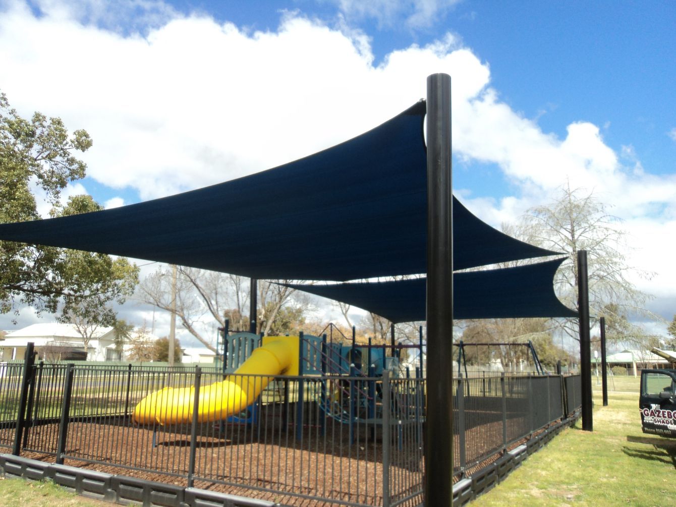 Playground Inside The Fence & A Dark Blue Shade Sails — Custom Blinds in Corowa, NSW