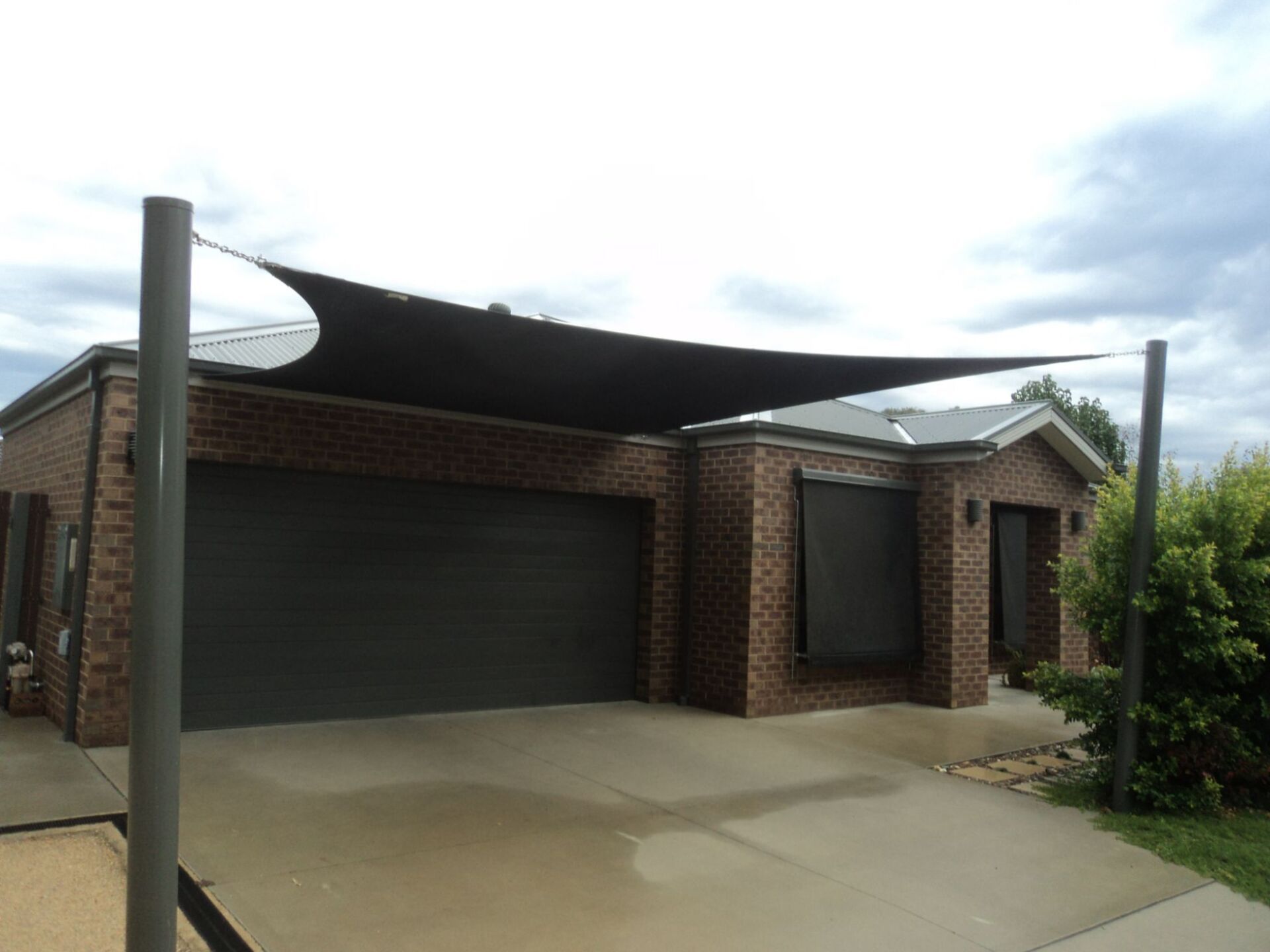Black Shade Sails At The Garage Door — Custom Blinds in Bright, NSW