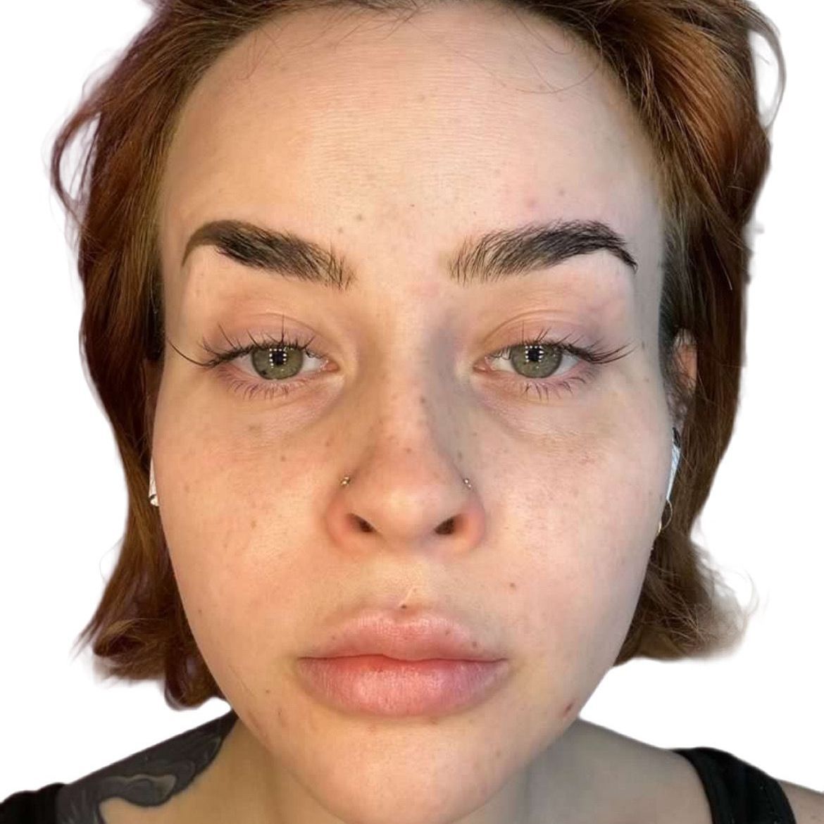 A close up of a woman 's face on a white background