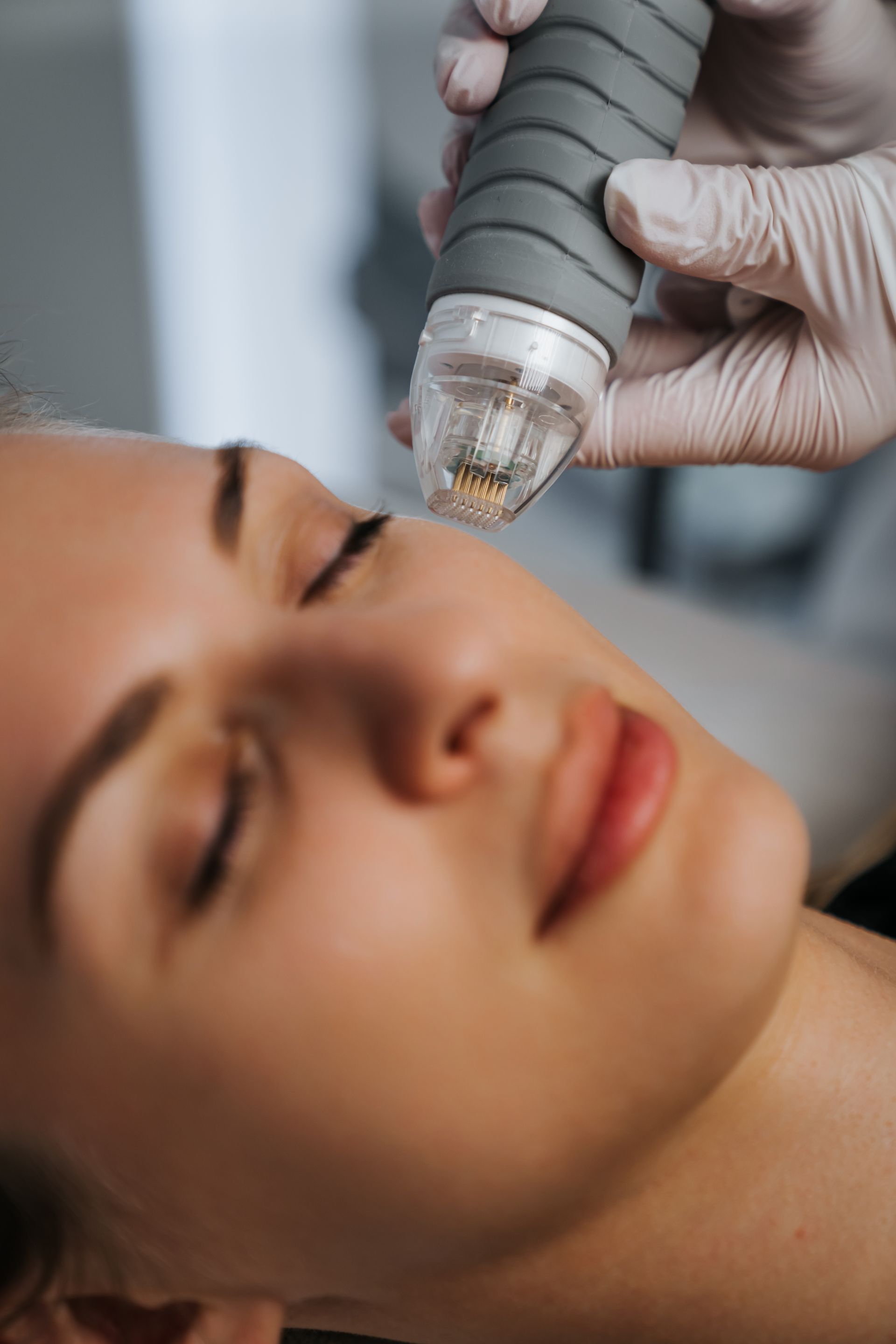 A woman is getting a facial treatment at a beauty salon.