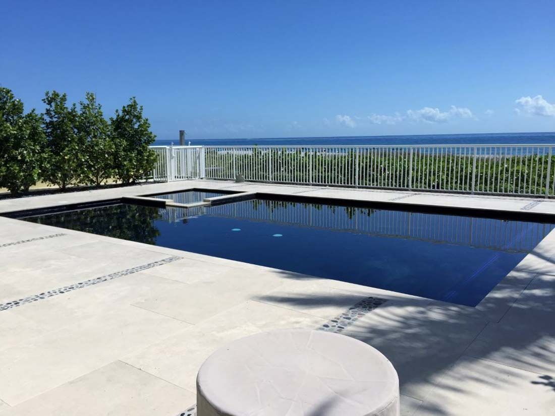 A large swimming pool with a view of the ocean
