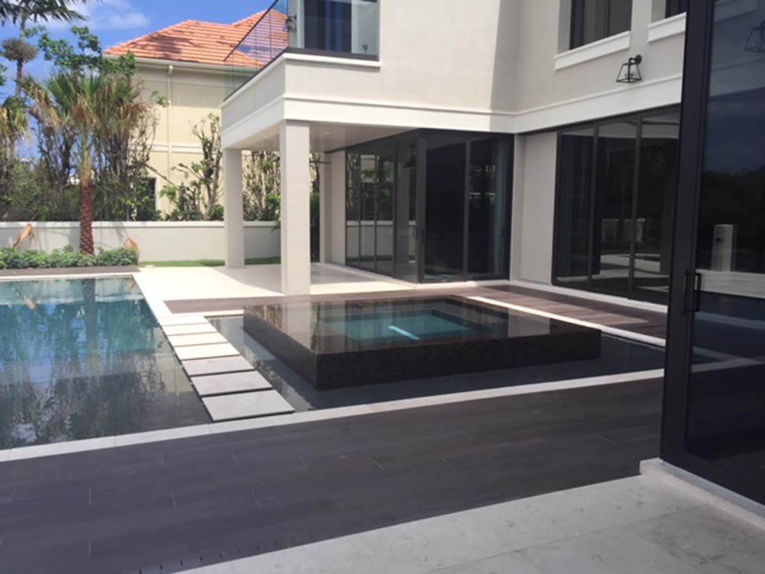 A large house with a large swimming pool in front of it