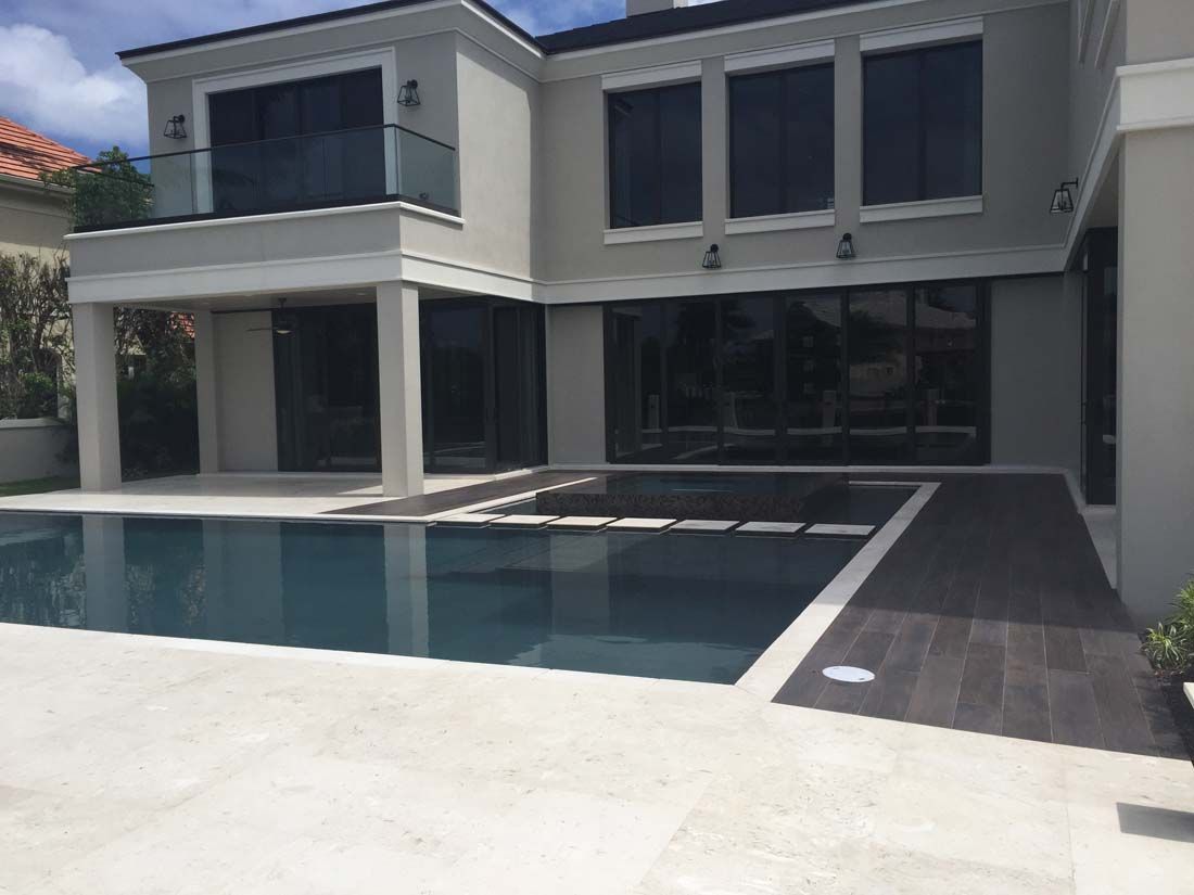 A large house with a swimming pool in front of it