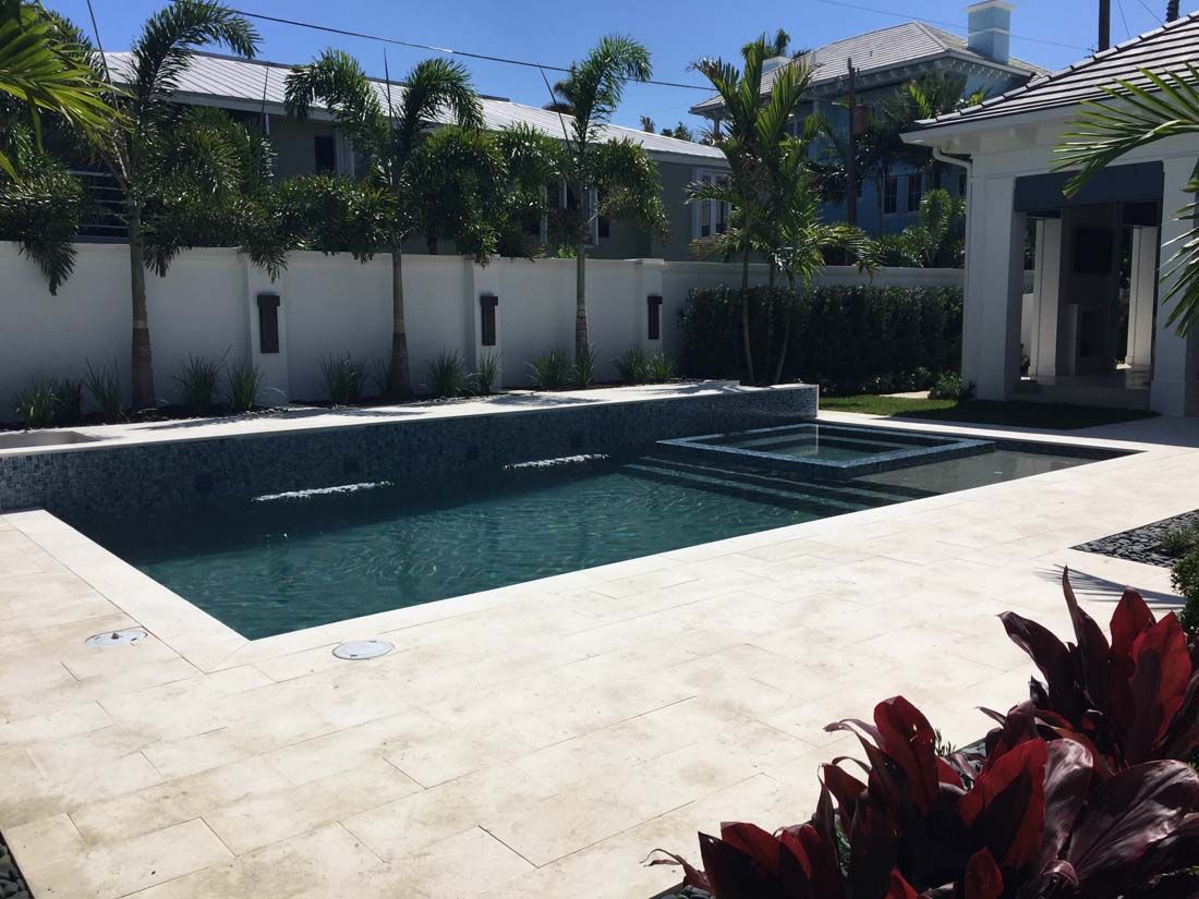A large swimming pool in the backyard of a house