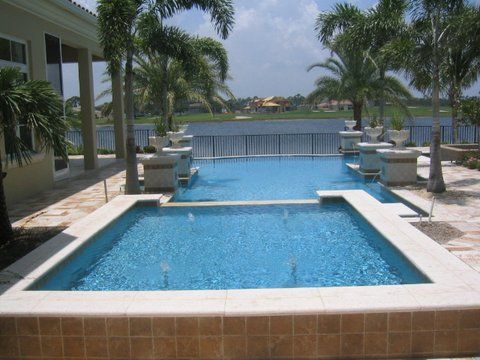 A large swimming pool with a view of a lake