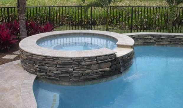 There is a hot tub in the middle of the pool.