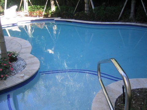 A large swimming pool with a staircase leading to it