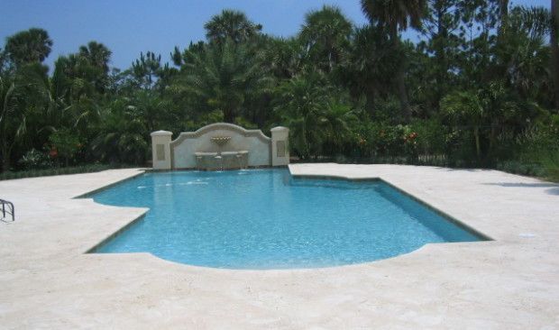 A large swimming pool with a fountain in the middle