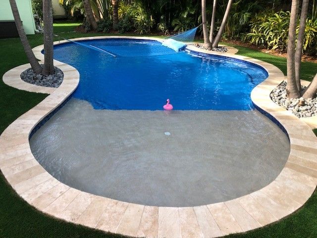 There is a pink flamingo in the middle of the pool.