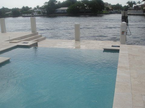 A large swimming pool with a view of a body of water