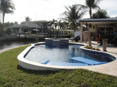 A large swimming pool in the backyard of a house