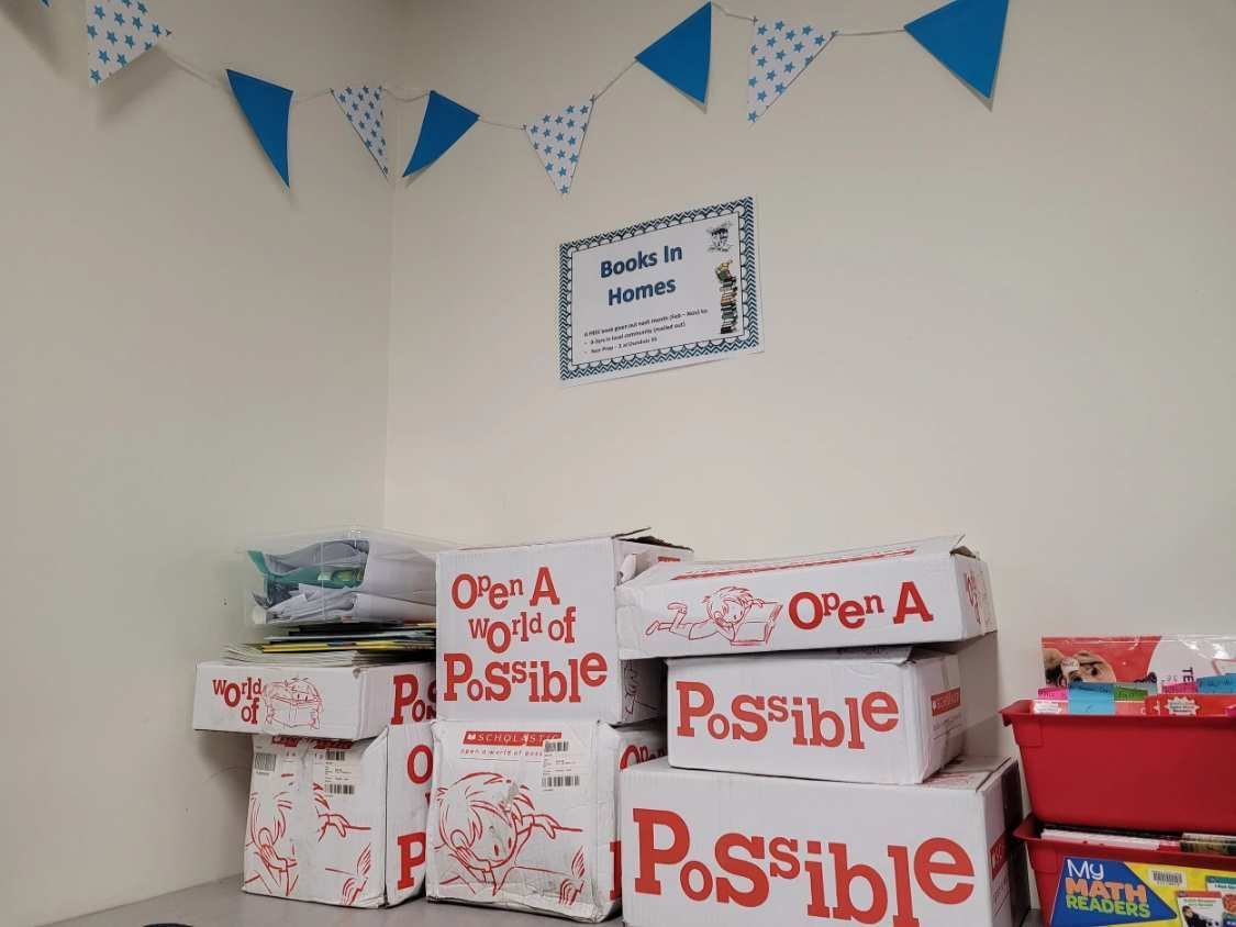 Boxes That Say Open a Possible Are Stacked in a Room With Bunting and a Sign That Says Guest in Home — Tincone Pty Ltd in Paget, QLD