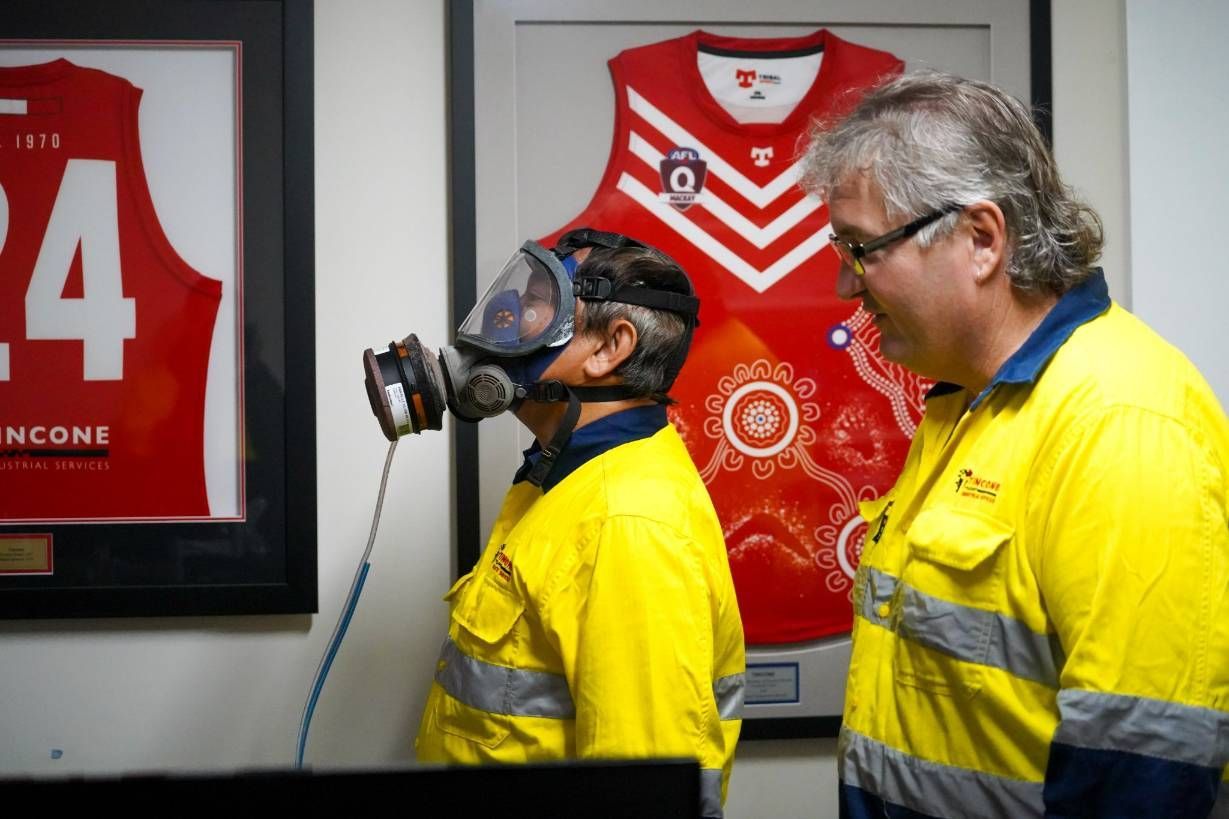 Two Men, One Wearing a Respirator Mask, the Other Observing — Tincone Pty Ltd in Paget, QLD