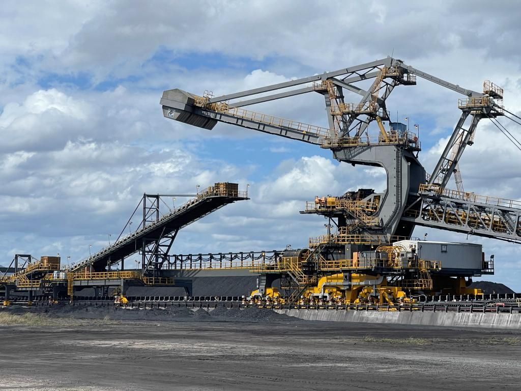 Large, Industrial Mining Machine With a Conveyor Belt, Operating Outdoors Under a Cloudy Sky — Tincone Pty Ltd in Paget, QLD