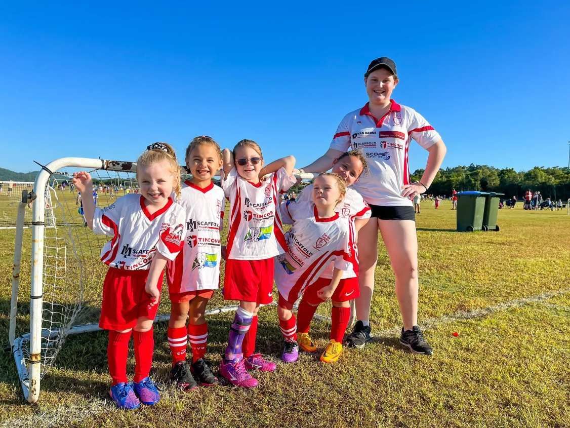 A Youth Soccer Team Poses With Their Coach on a Field — Tincone Pty Ltd in Paget, QLD